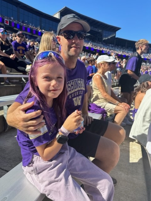 Jay Bjorn founder of Chinook Services and daughter Gretchen, attending Huskies Football game