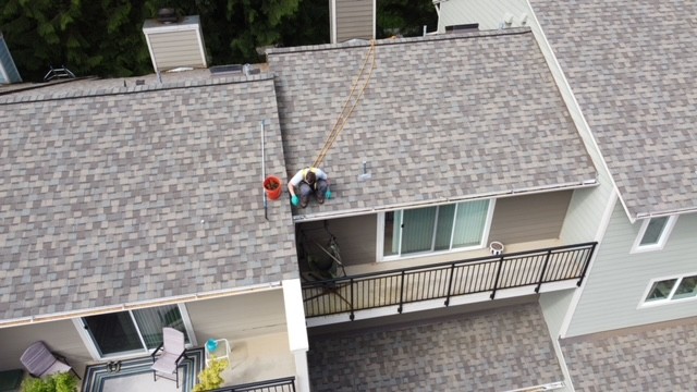 Chinook Services worker cleaning gutter in Marysville. Captured by drone. Chinook being a local top rated provider for gutter cleaning in Marysville for over 20 years.