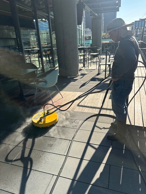 Pressure washing commercial patio exterior dining area by Chinook Services in Seattle, WA