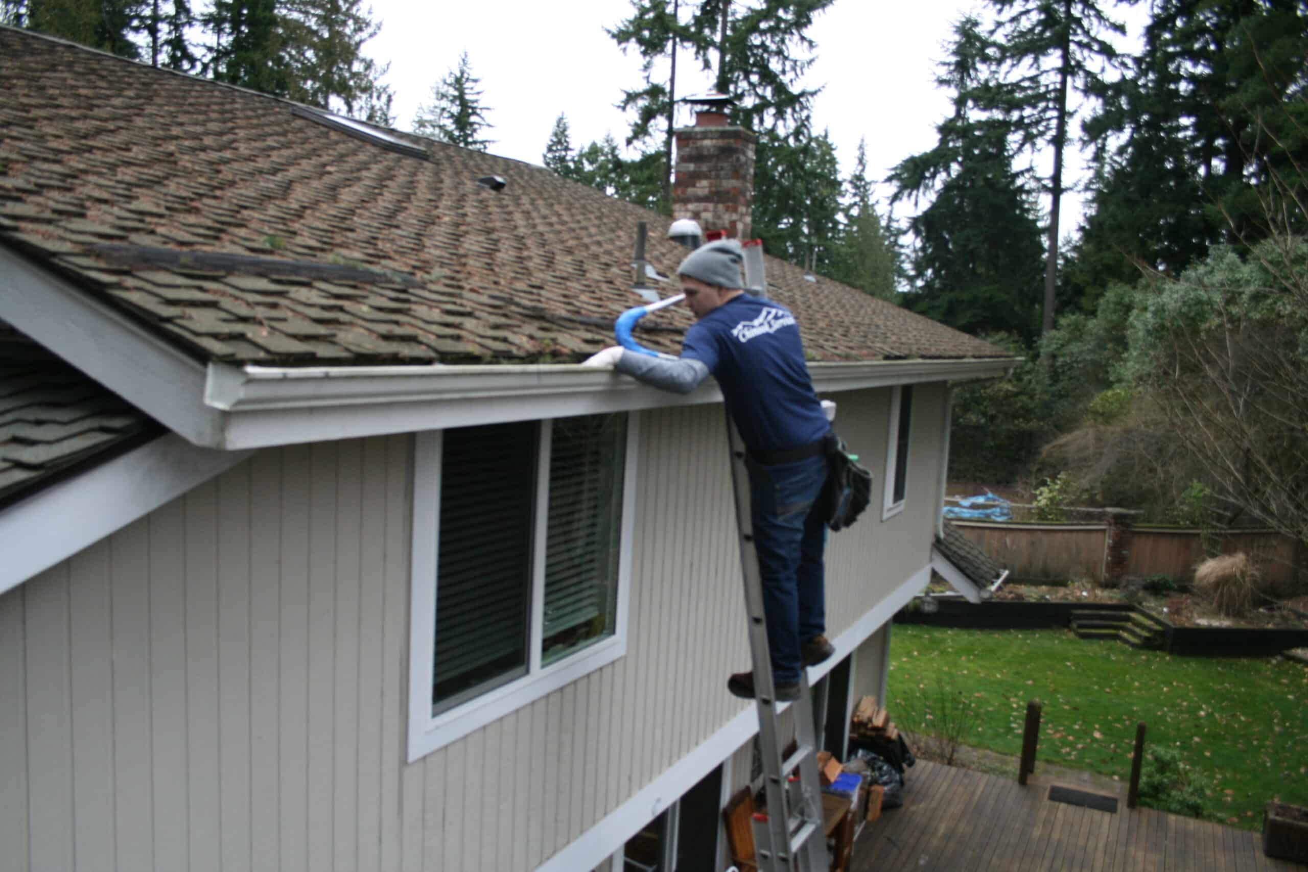 Alki Beach gutter cleaning worker