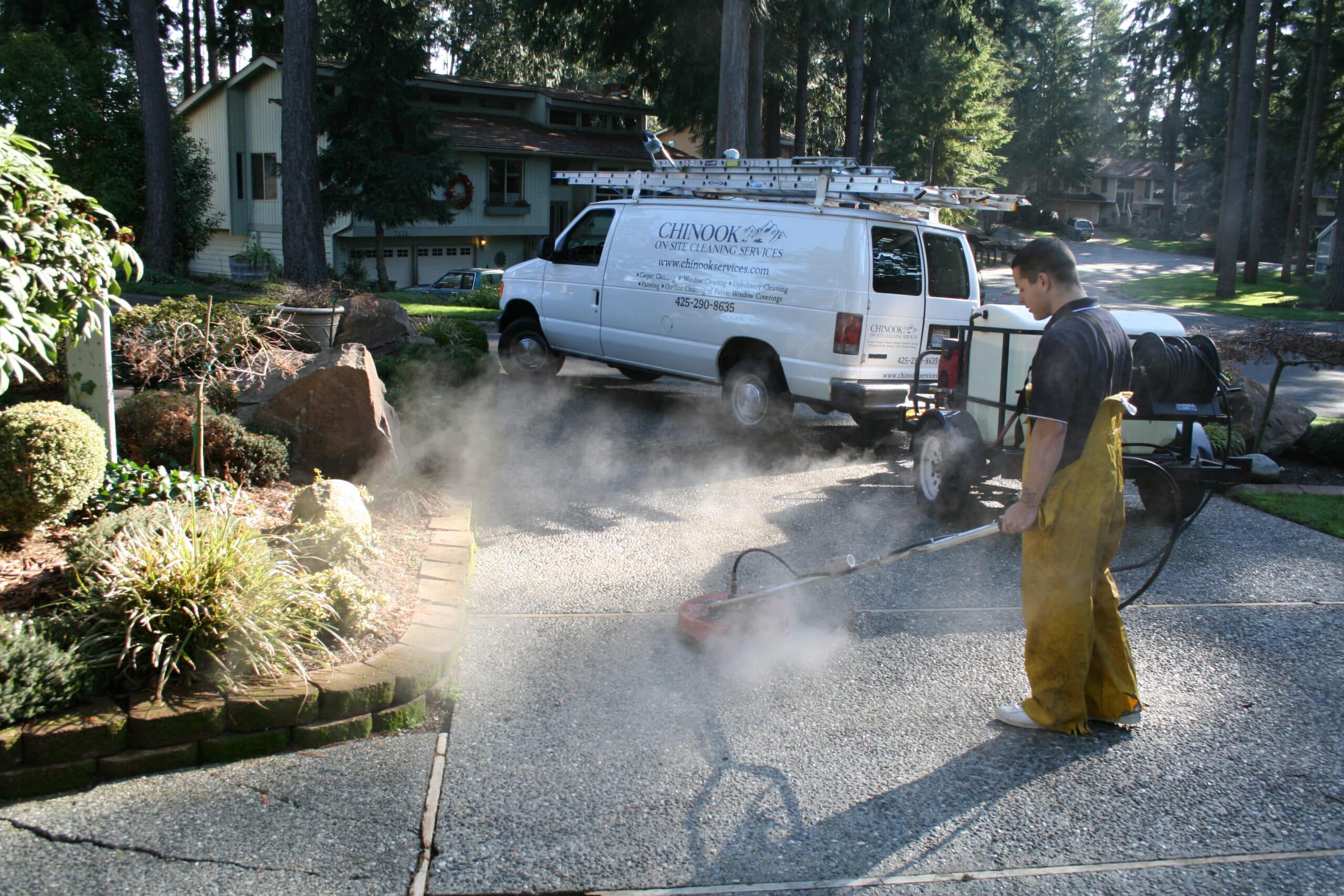 worker pressure washing driveway in Ames Lake area of Washington State