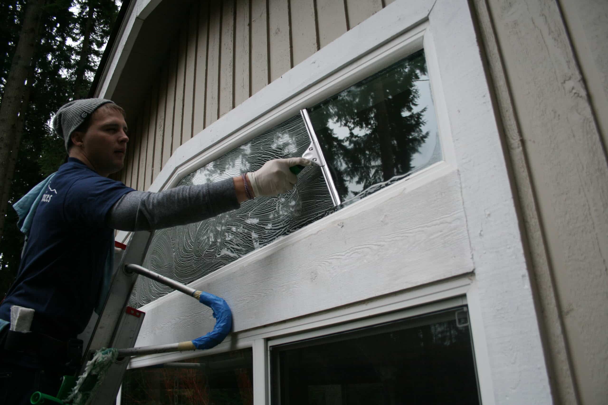 Hand cleaning a window in Bridle Trails