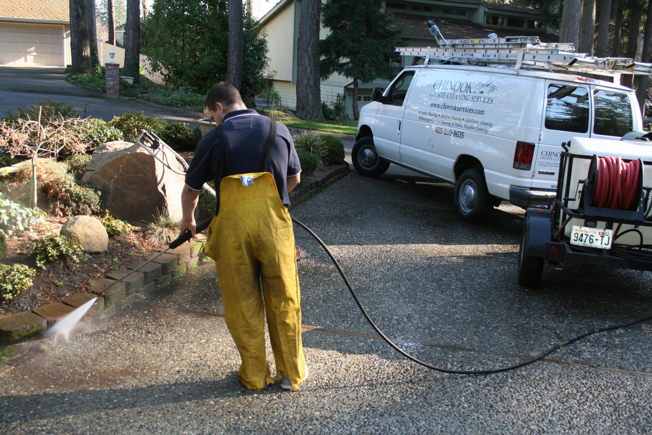 Cleaning driveway and walls of driveway in Clyde Hill using pressure washing