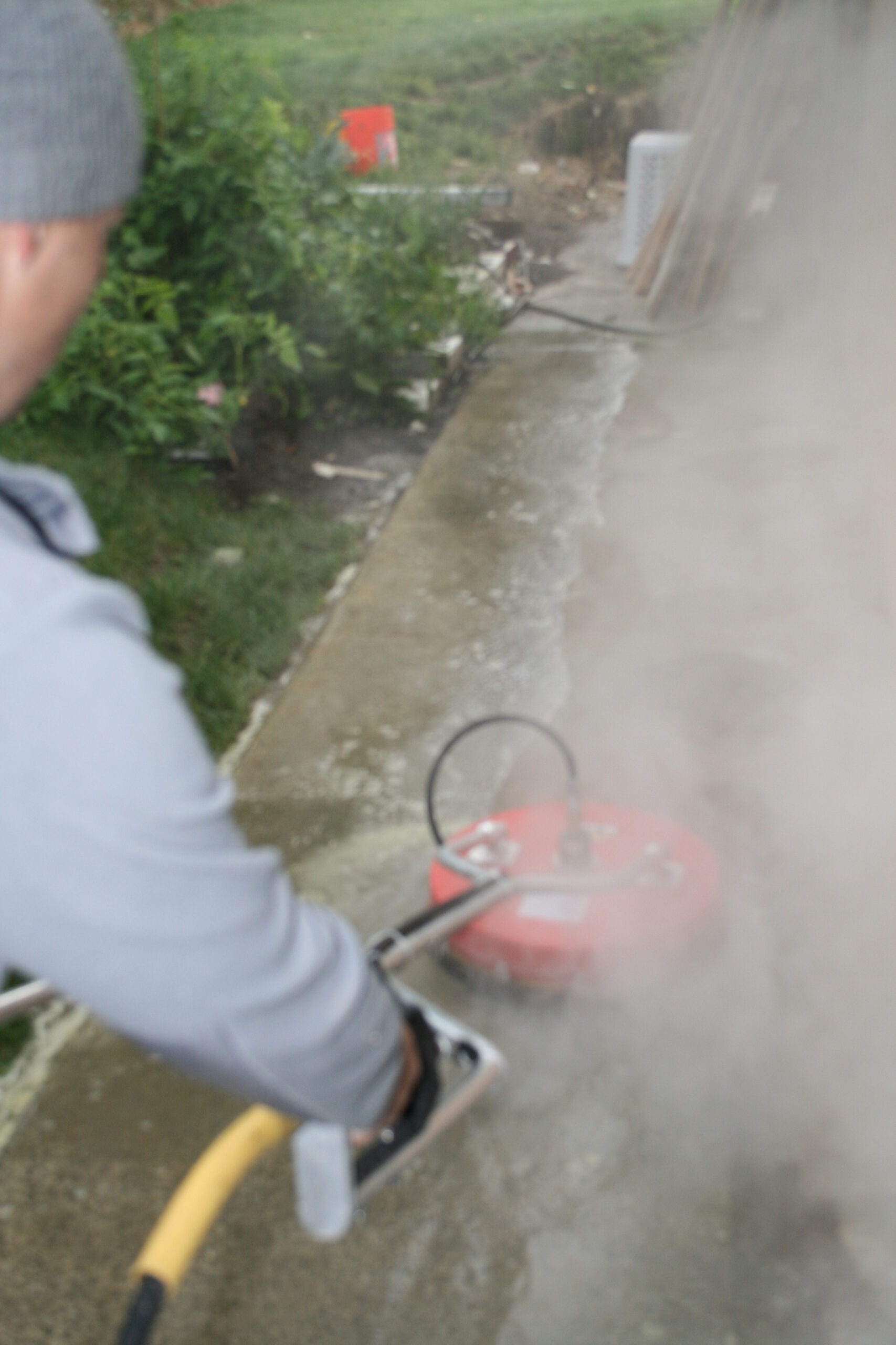 Pressure washing driveway of home in the Juanita area of Kirkland, WA