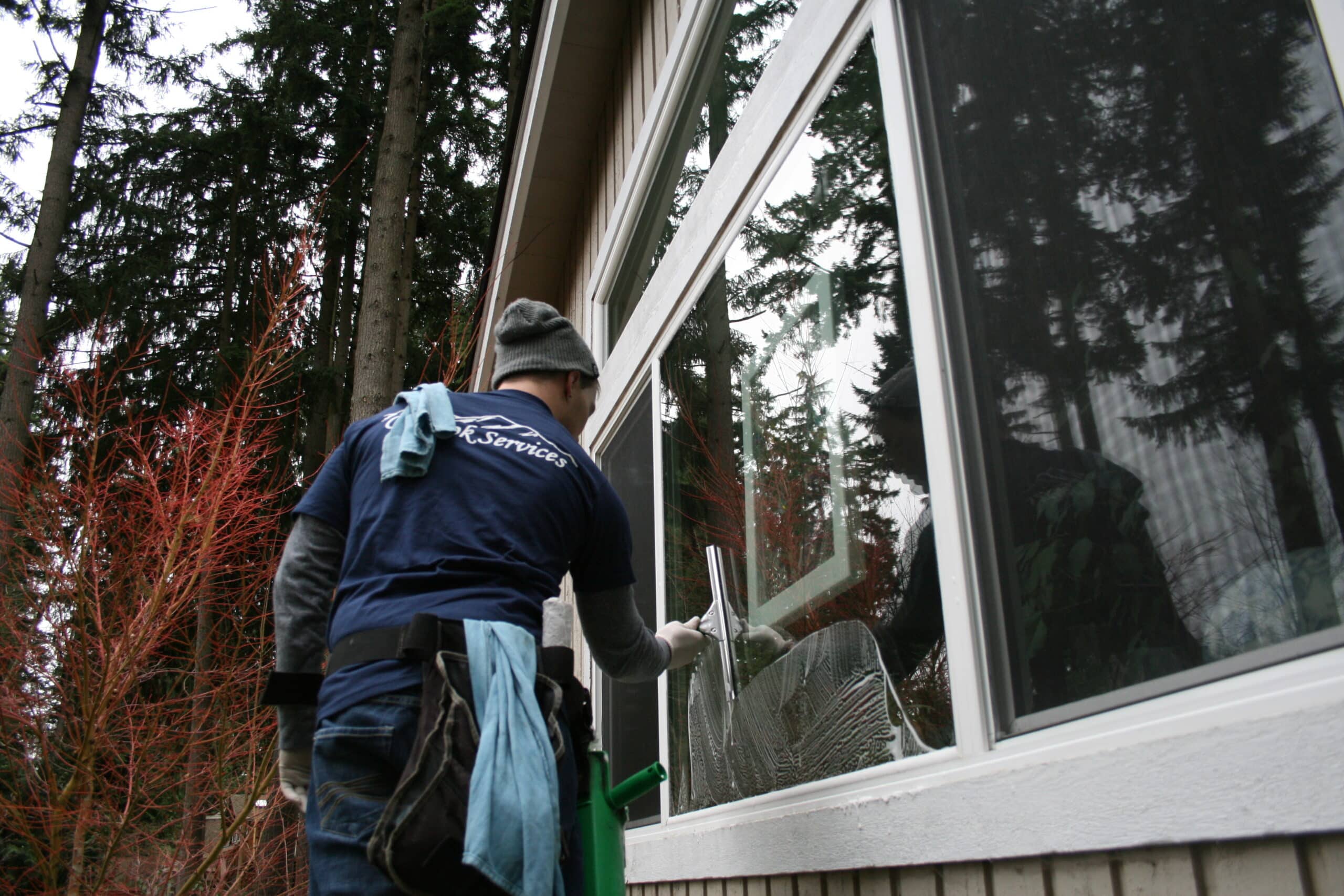 Cleaning multiple window panes on exterior of Kenmore, WA home.