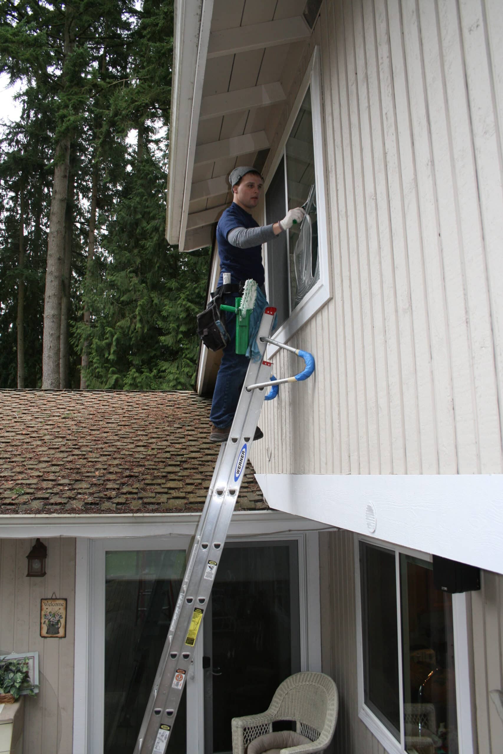 Cleaning windows on a second story Kingsgate home
