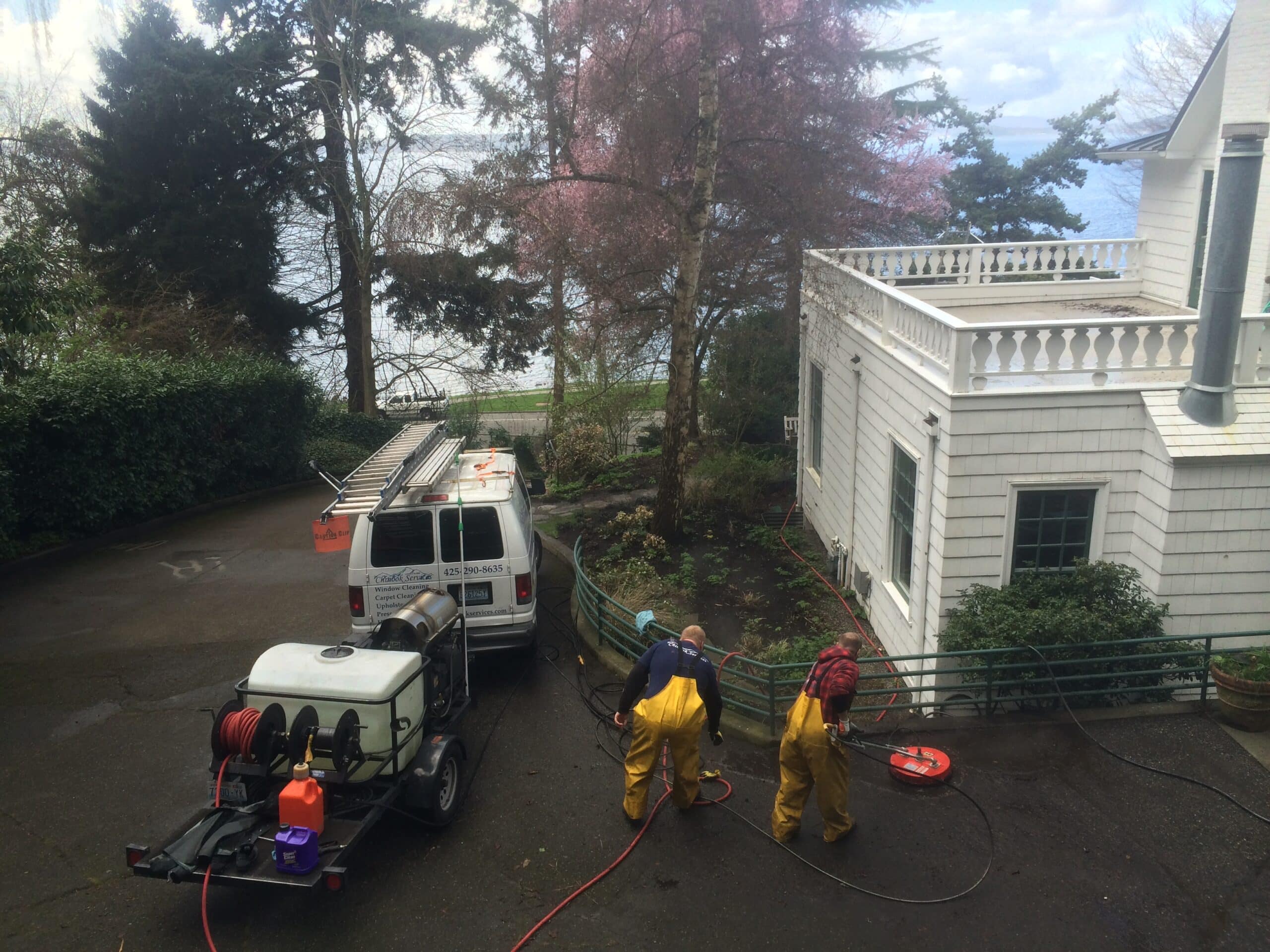 Two worker pressure washing Alki Beach property