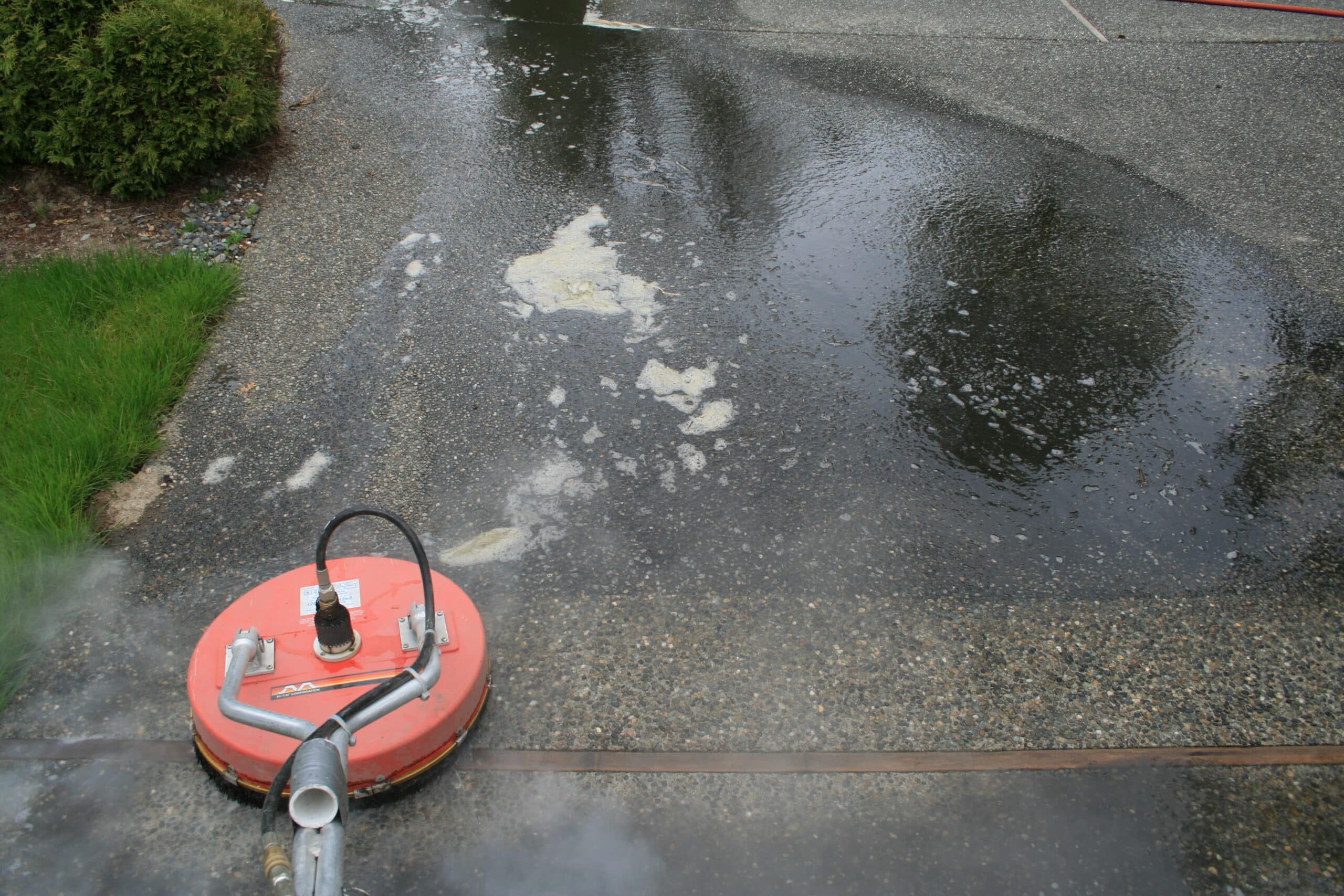 Pressure washing using disc rotary surface cleaning tool cleaning Union Hill driveway.
