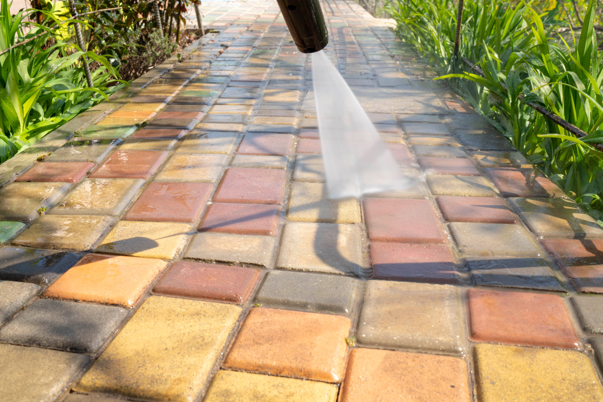 Using pressure washer to clean concrete and pavers in Ravenna neighborhood of Seattle, WA