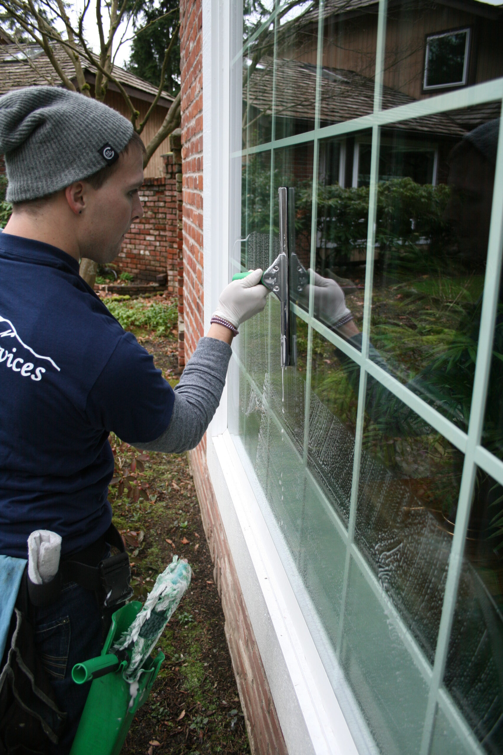 Hand washing and cleaning window in University District Seattle, WA