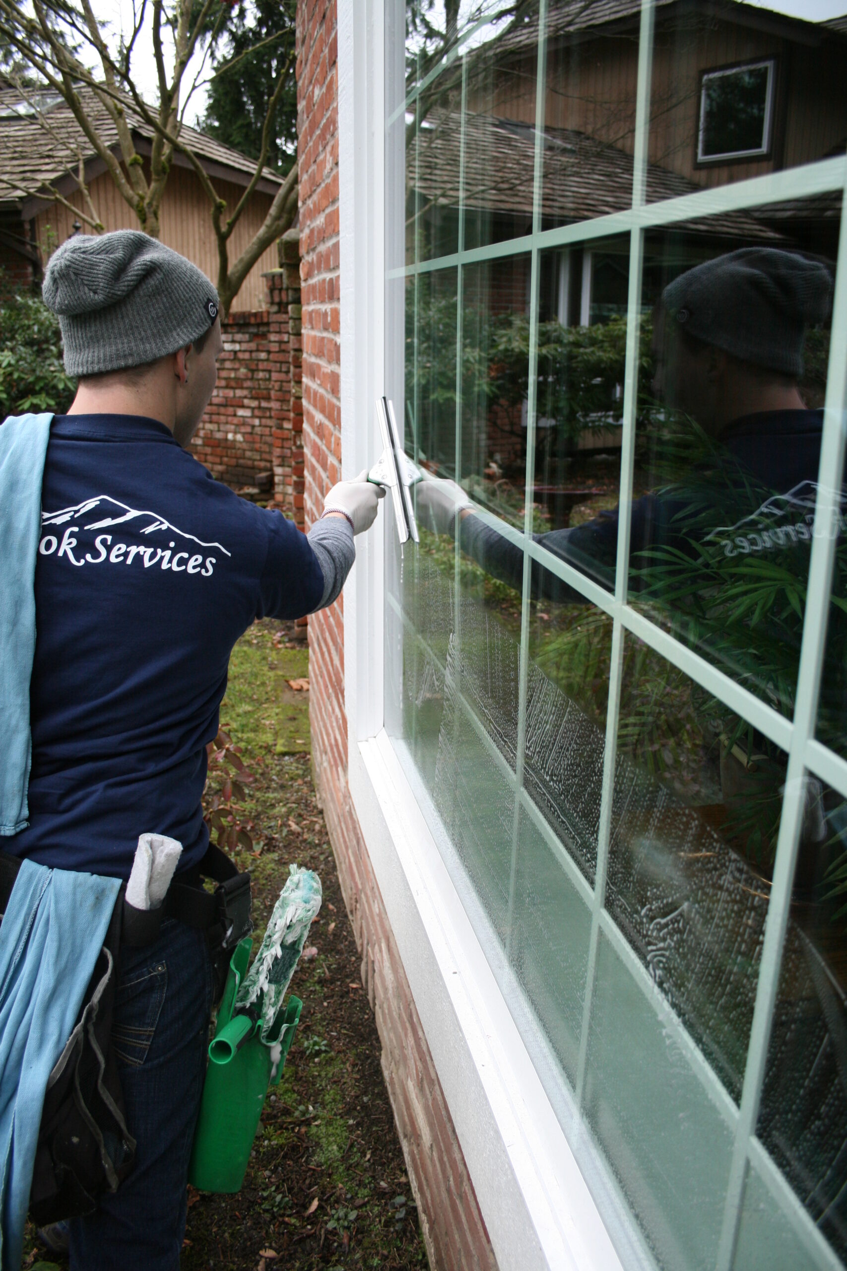 Squeegee cleaning windows in Wallingford neighborhood in Seattle